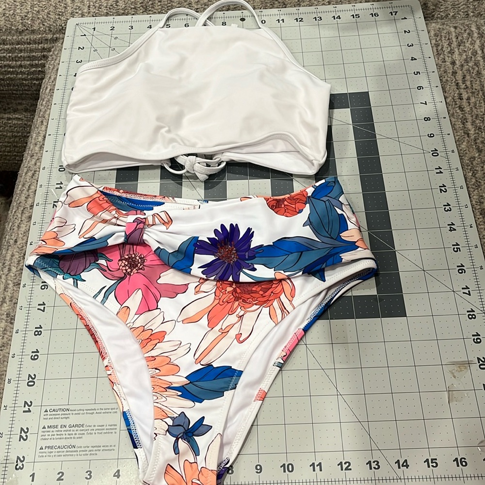 Ladies’ two-piece w/high-waisted bottoms and lace-up tankini style top.
